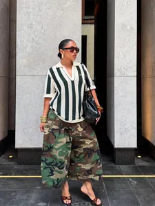Detail showing street style camouflage wide-leg cargo pants with functional pockets.