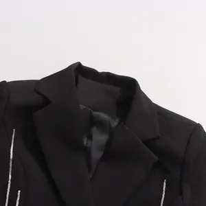 Close-up detail of black blazer collar with elegant silver sequin trim and satin lining