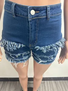 Close-up detail of high-waisted denim shorts with frayed fringe design