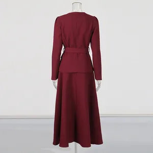 Back view of burgundy French vintage two-piece set featuring long sleeve top and maxi skirt