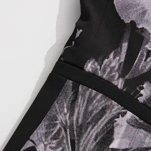 Close-up detail of black botanical floral print fabric on high-quality leisure suit blazer
