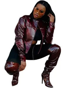 Trendy burgundy shiny cropped leather jacket paired with matching high heel thigh boots