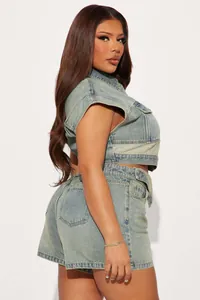 Side view of a trendy patchwork denim two-piece set featuring vest top and shorts