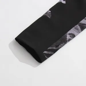 Detailed close-up view of the elegant floral print sleeve cuff on a black blazer jacket