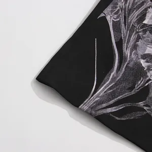 Close-up of the detailed white floral graphic print on black fabric for fashion suit