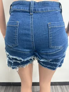 Back view of stylish slim denim shorts featuring a frayed tassel hem and back pockets.