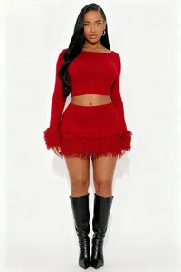 Chic red knit two-piece set featuring fringe long sleeves and a matching mini skirt