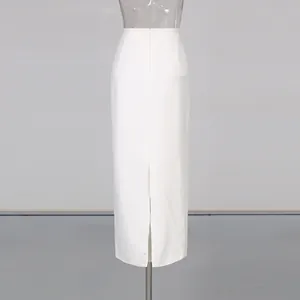 Rear view detail of a high-waisted white pencil skirt featuring a center back slit