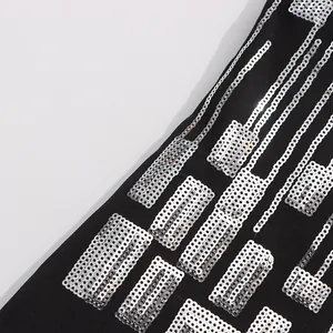 Macro detail of silver rectangular sequins on black high-quality fabric garment