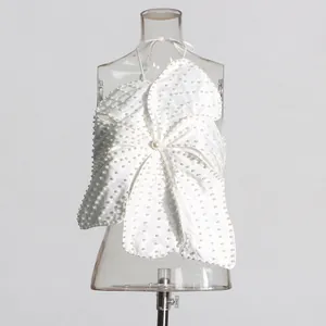 Macro view of detailed white pearl beading on a flower-shaped halter top design