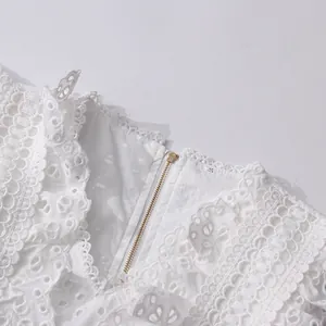 Detail view of a white French vintage lace embroidery hollowed-out top with a metal zipper
