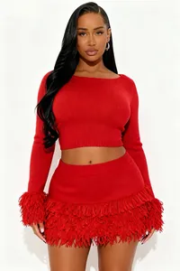Detailed view of a vibrant red knit two-piece set with stylish fringe trim details