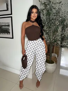 Detail shot of chic polka dot wide-leg pants paired with a brown halter top