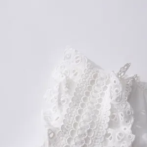 Close-up of white French vintage lace embroidery with delicate hollow eyelet detailing.