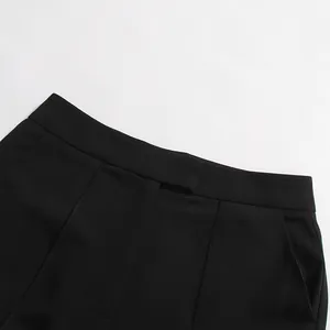 Close-up of black suit pants waistband showing clean stitching and fabric texture.