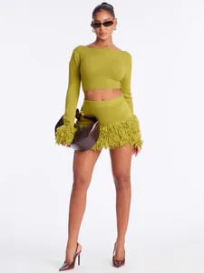 Stylish olive green knit two-piece set featuring a long sleeve crop top and fringe mini skirt