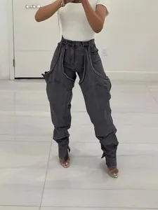 Detailed view of dark grey irregular cut-out denim jeans featuring unique asymmetric stitching