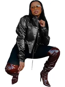 Detailed view of a stylish black cropped PU leather jacket paired with trendy thigh-high boots.