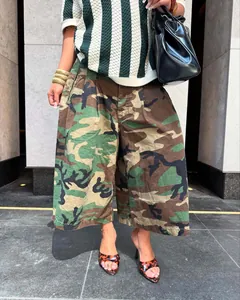 Fashionable streetwear women's wide-leg camouflage pants in a casual outdoor setting