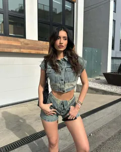 Fashionable two-piece denim set featuring a cropped vest and high-waist shorts for women