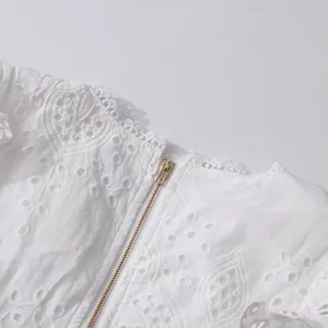 Close-up detail of white French retro lace embroidery with high-quality metal zipper.