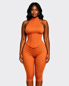 Vue détaillée d'une combinaison dos nu orange à pois avec une taille corsetée élégante