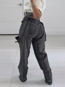 Close-up detail of dark grey irregular cutout jeans featuring a unique zipper patchwork design