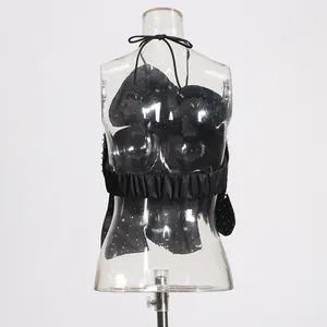 Close-up detail of sexy black halter neck top with heavy beadwork on mannequin
