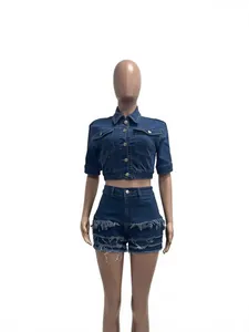 Fashionable dark blue denim two-piece set with slim-fit jacket and frayed fringe shorts