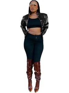 Full view of slim cropped black leather jacket for women in street fashion style.