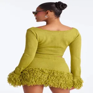 Back view of lime green knit two-piece set with long sleeves and fringe skirt
