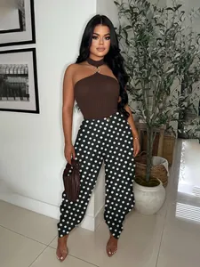 Detailed view of fashionable high-waisted black and white polka dot wide-leg cropped pants