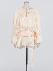 Champagne puff sleeve pleated mini dress with tie waist and ruffle hem details