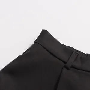 Close-up detail shot of black straight trousers waistband with belt loops and elastic back design