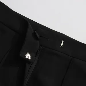 Detailed macro view of black suit pants waistband with high-quality zipper and button closure