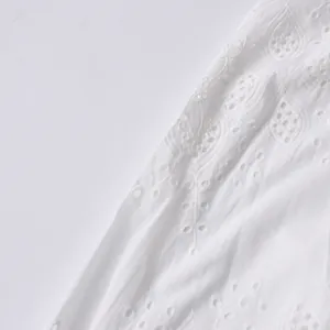 Close-up detail of white vintage lace embroidery with a delicate openwork pattern