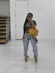 Modern high-waisted irregular cutout stretch denim jeans featuring stylish zipper details