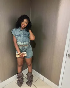 Fashionable women's two-piece denim set featuring a sleeveless vest and color-block mini skirt.