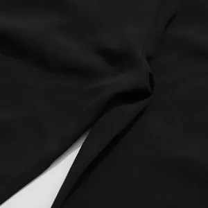 Macro detail of the high-quality black textile fabric showing tight weave texture