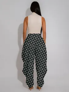 Detailed back view showing the fit and pattern of black and white polka dot lantern pants