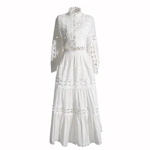 Detailed view of white eyelet lace texture on hollow-out cropped top and tiered skirt