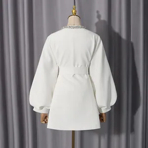 Back view of elegant white jacket with rhinestone collar and belted puff sleeves