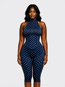 Élégante combinaison dos nu à pois bleu marine avec corset et coupe ajustée moderne