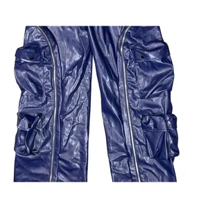Detailed macro view of blue faux leather cargo pants featuring metal zippers and multi-pockets