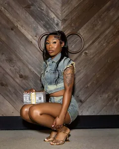 Stylish patched denim two-piece set featuring a sleeveless vest and matching shorts on model