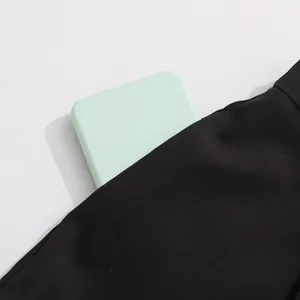 Detail view of a black suit pocket showing storage capacity for a smartphone.