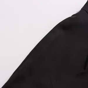 Close-up view showing the smooth texture of high-end black suit fabric material