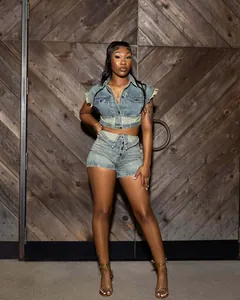 Detail showing the two-tone denim crop top and high-waist shorts set on a model