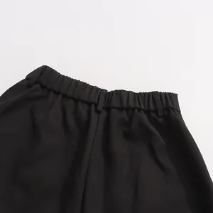 Close-up of comfortable elastic waistband on women's black straight-leg suit trousers