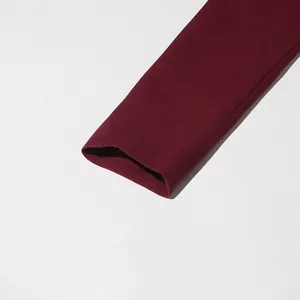 High-quality close-up detail of wine red French vintage style suit sleeve cuff texture